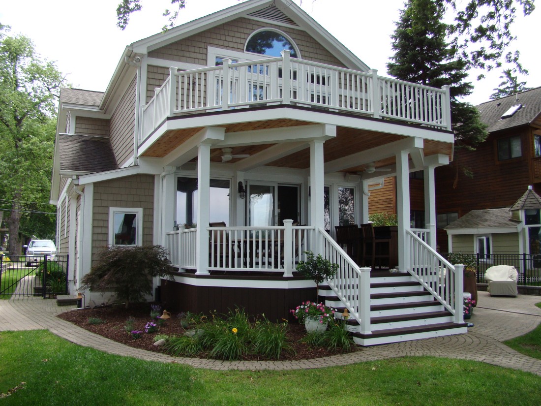 Two-story house with a white deck and staircase