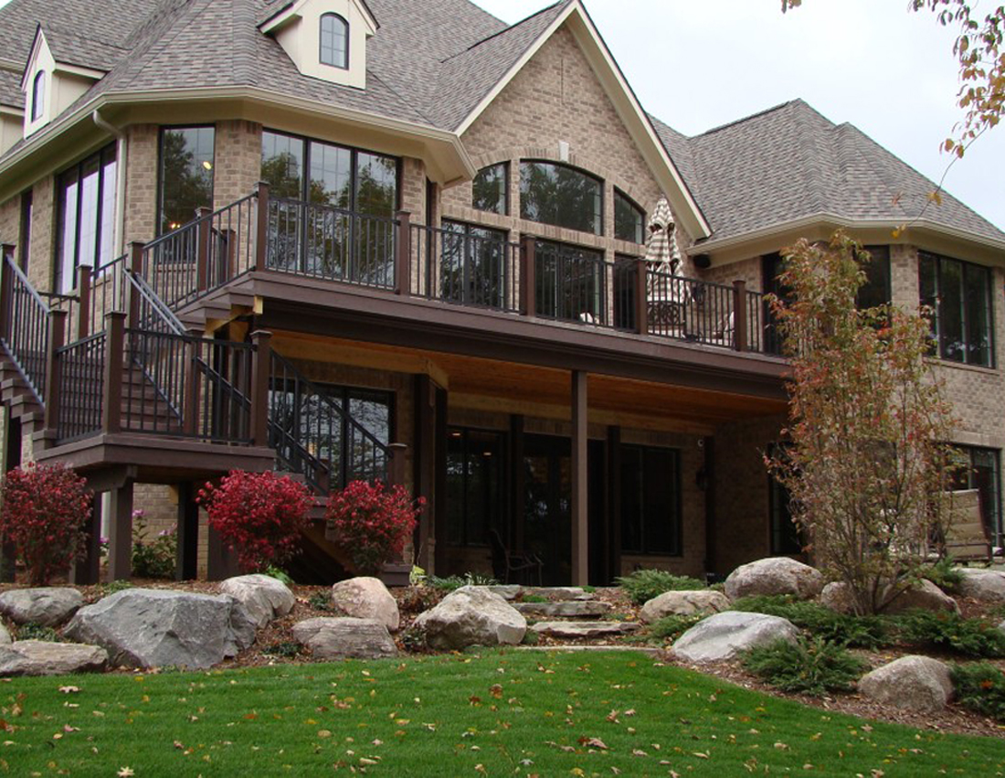 Elevated deck with black metal railings and staircase.