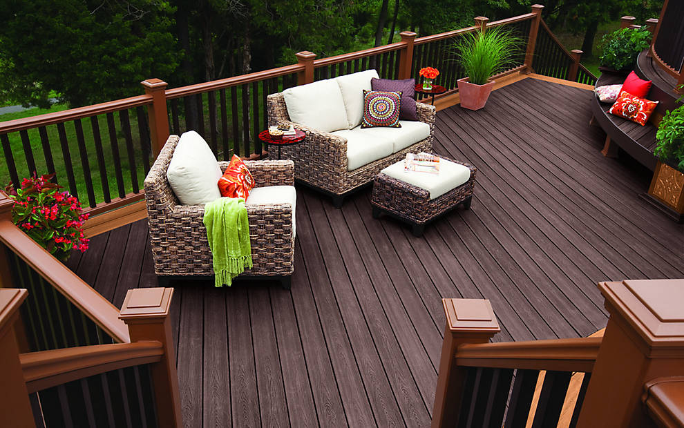 A durable Trex composite deck with a dark stain and lighter railing, built by Cedar Works